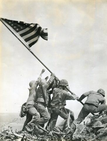 Raising the flag on Iwo Jima Archives Branch, USMC History Division, CC BY 2.0 <https://creativecommons.org/licenses/by/2.0>, via Wikimedia Commons