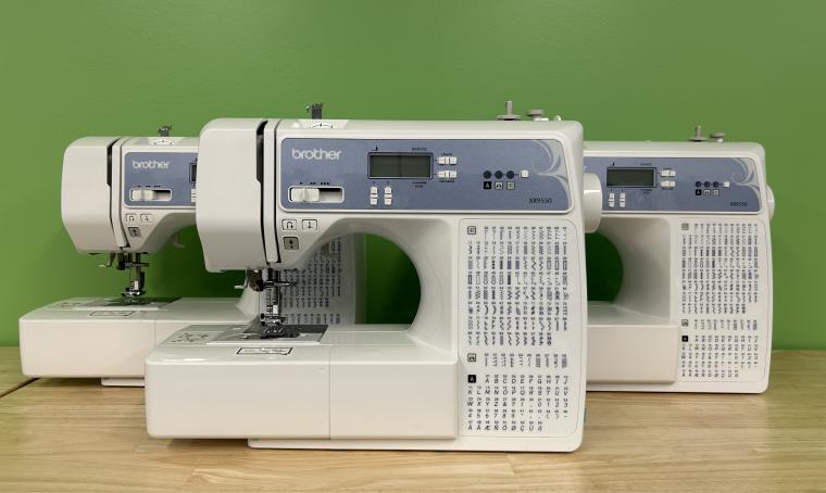 Three Brother XR9550 sewing machines against a green background.