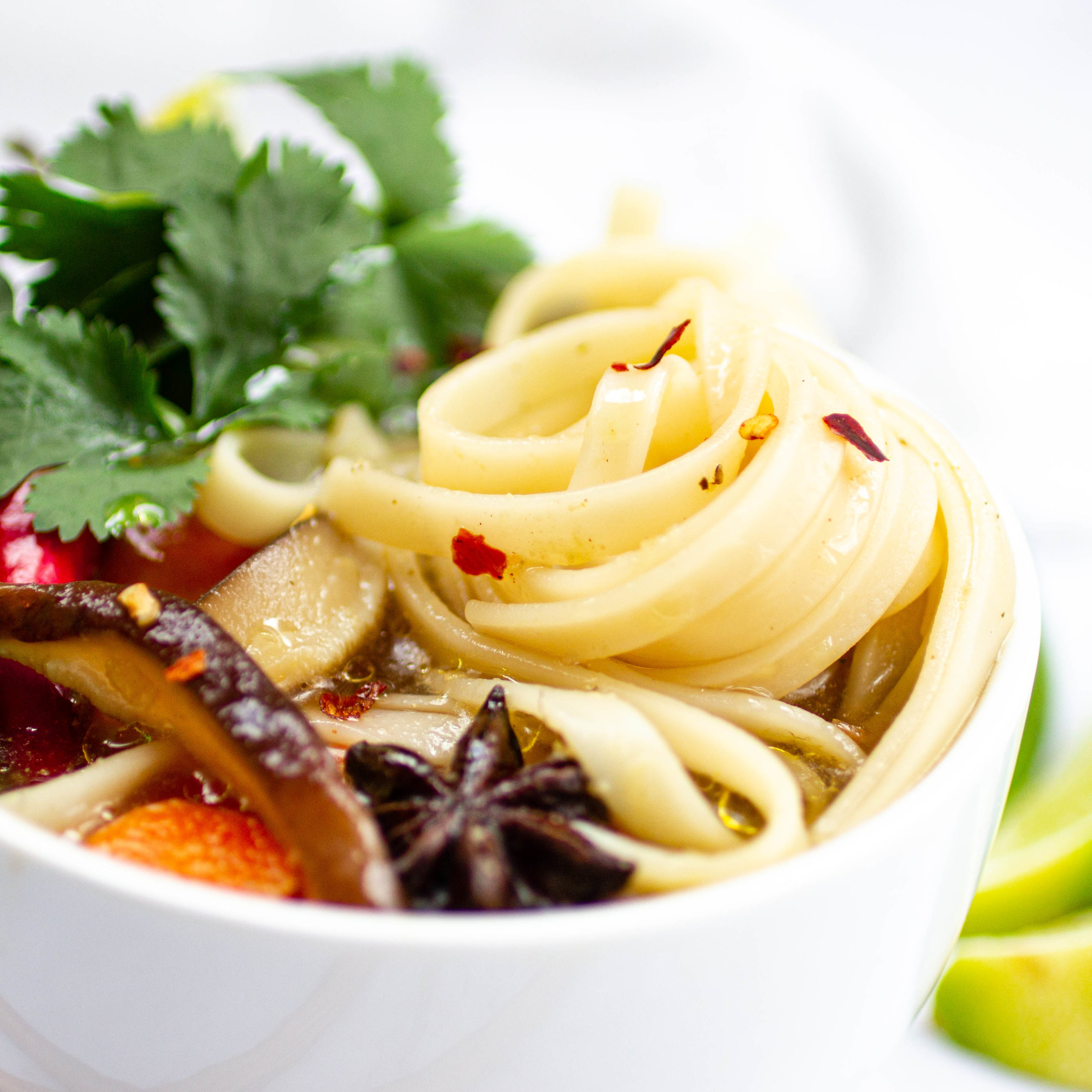 Bowl of soup with noodles, mushrooms and star anise