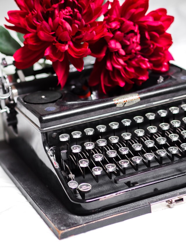 Roses on a typewriter Photo by Laura Chouette on Unsplash