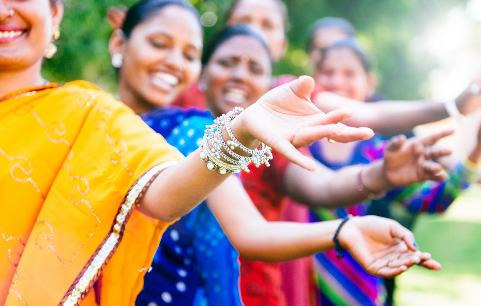 A group women dancing with their hands in different positions