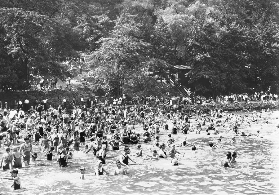 Crowd of people swimming in a river
