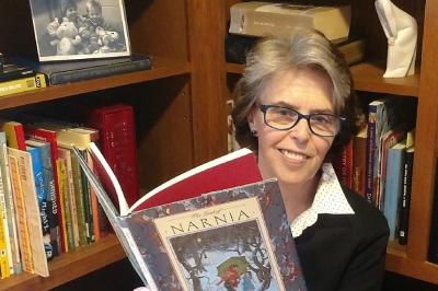 Scarsdale librarian Eileen Corbett holding book
