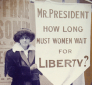 Suffragette with sign Mr. President How long must women wait for liberty?