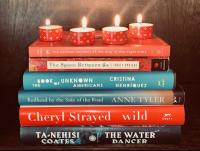 May Literary Birthdays banner depicting a stack of books by the authors with celebratory tea lights lit on top