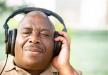 Image of a man with headphones on and his eyes closed